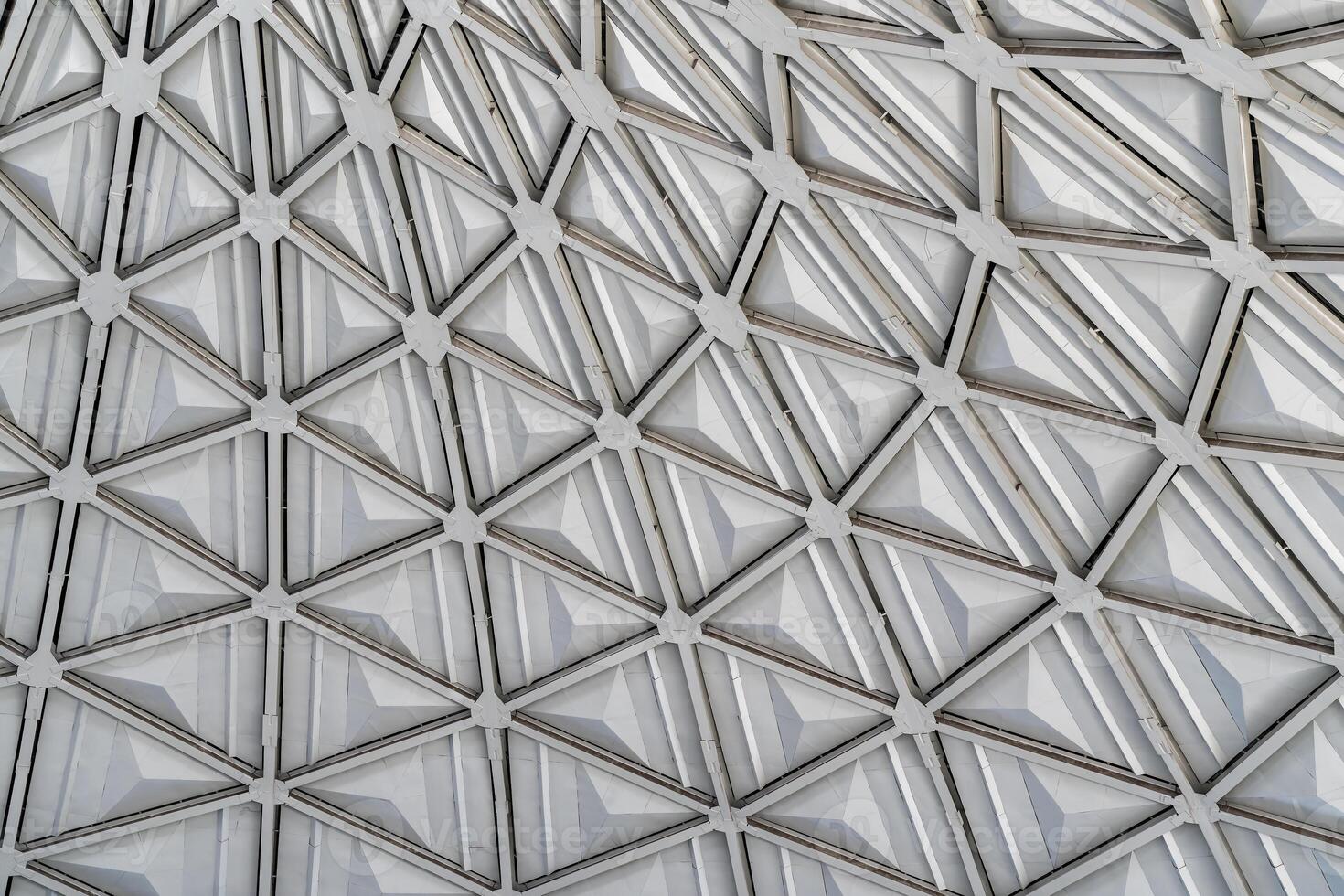 The steel inner part of the roof with the framework of the Chorsu Bazaar in Tashkent. Geometric architectural background. photo