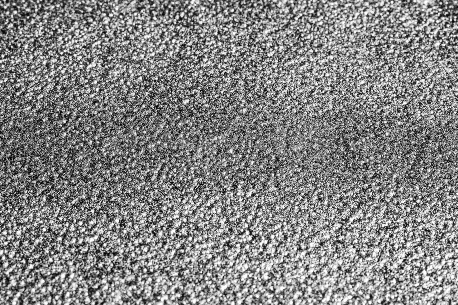 Monochrome texture of shiny grained metal. Abstract background. photo