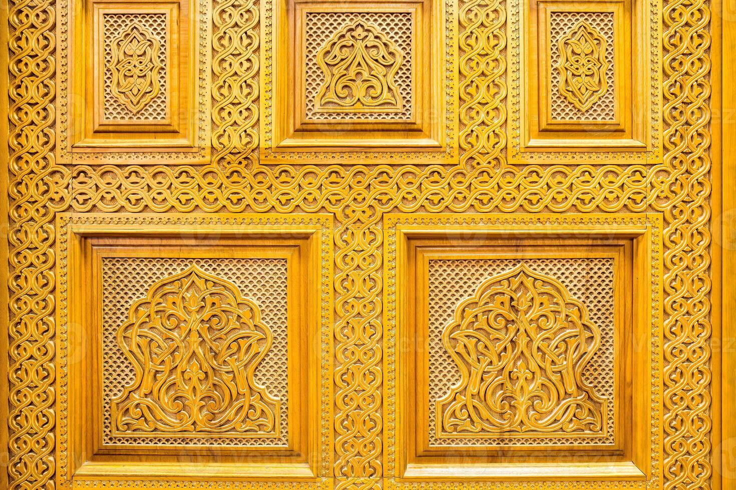 Carved wooden doors with patterns and mosaics. Abstract background. photo