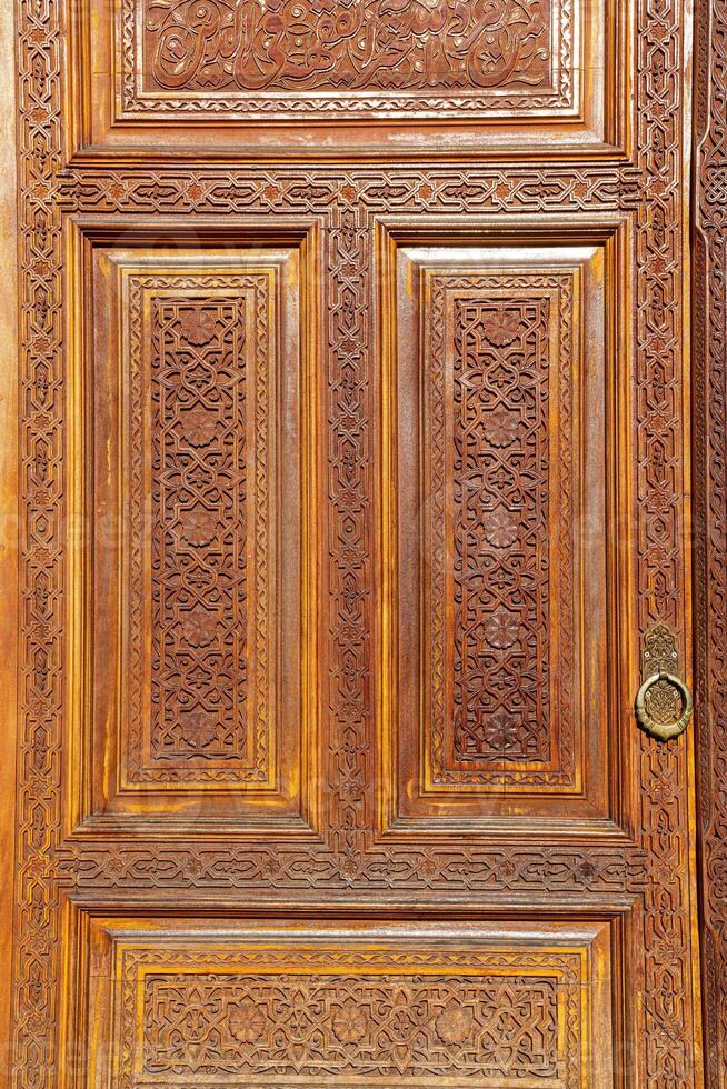 Carved wooden doors with patterns and mosaics. photo