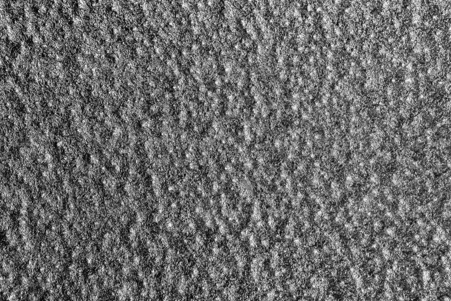 monocromo textura de brillante granulado metal. resumen antecedentes. foto