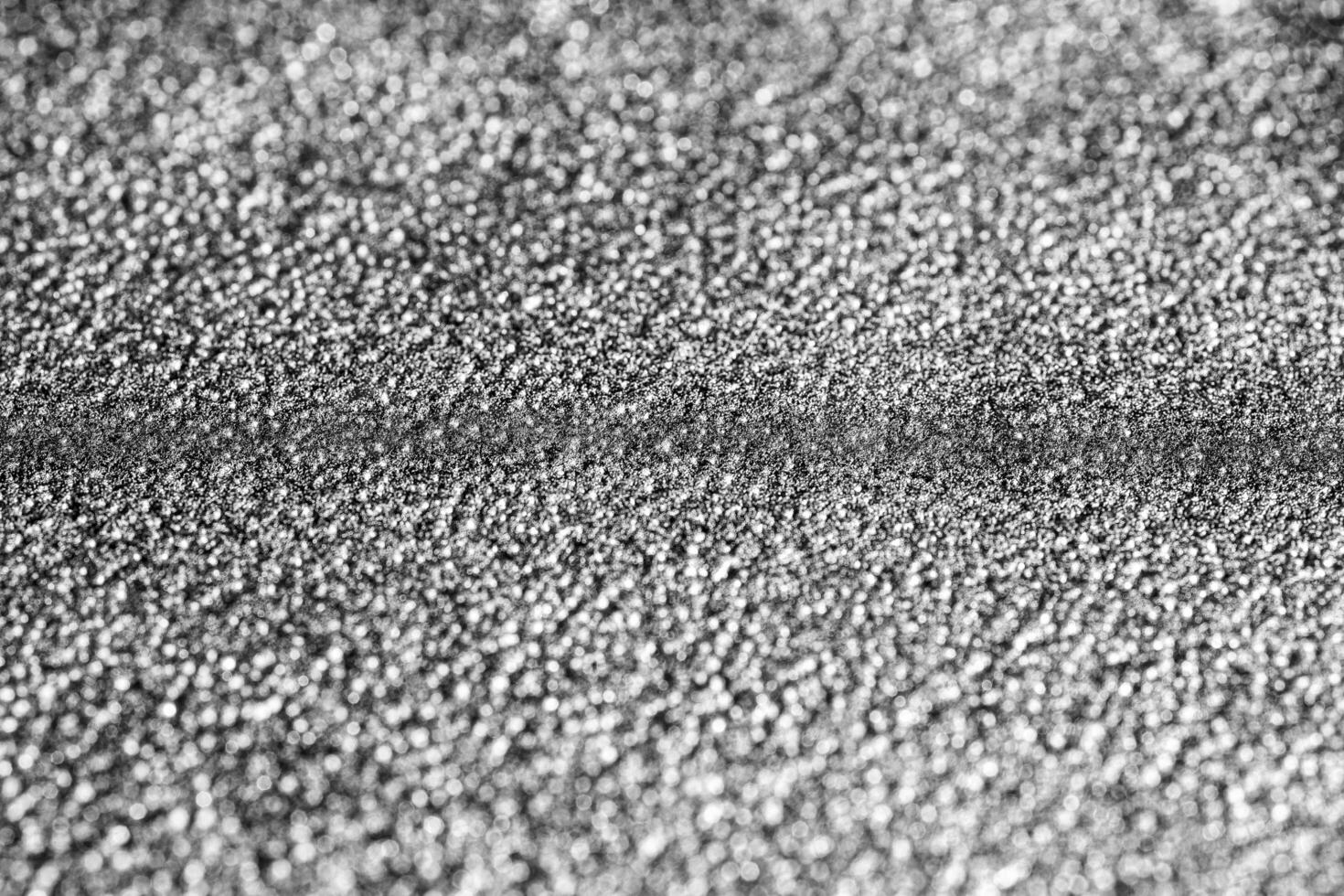 Monochrome texture of shiny grained metal. Abstract background. photo