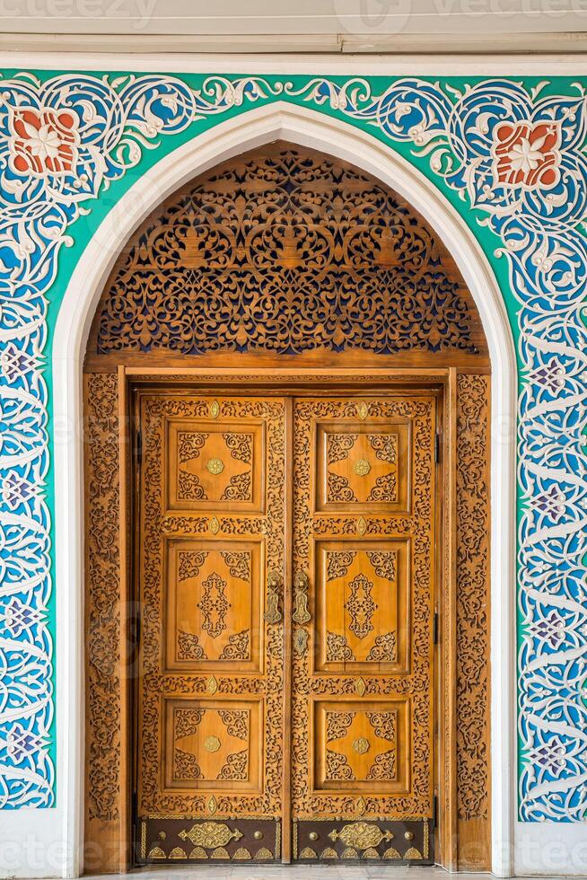 Carved wooden doors with patterns and mosaics. Abstract background. photo