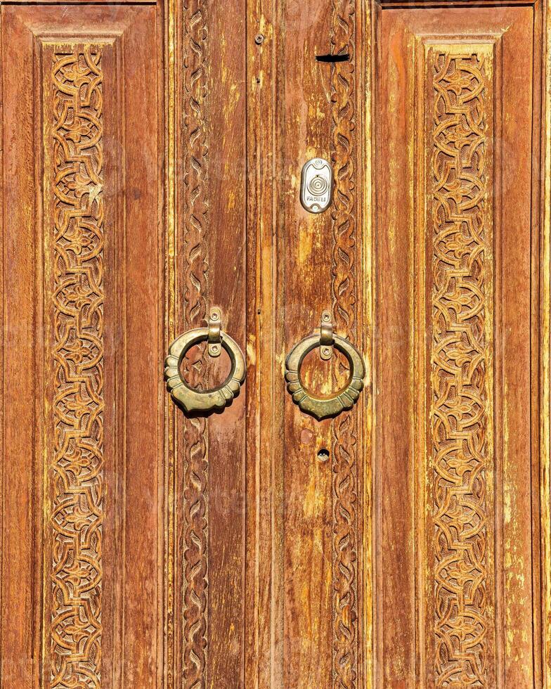 Carved wooden doors with patterns and mosaics. photo