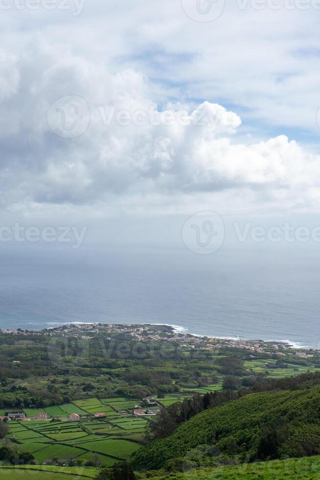 Aerial view of Porto Martins on Terceira Island, Azores, with the vast Atlantic Ocean as backdrop. Stunning coastal landscape captured from above. photo