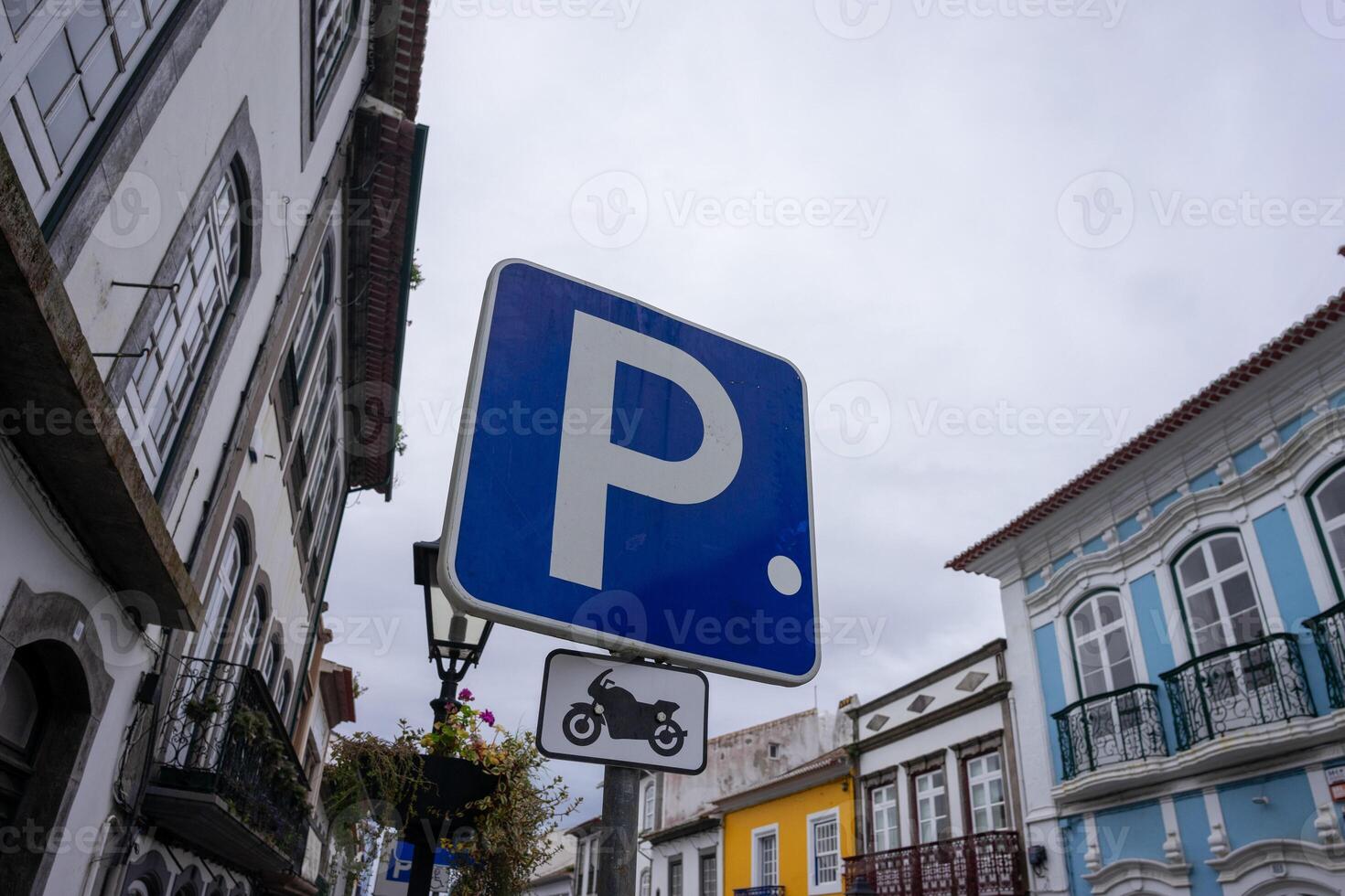 Motorcycle parking sign against a vibrant urban backdrop. Perfect for illustrating designated parking areas in cityscapes. photo