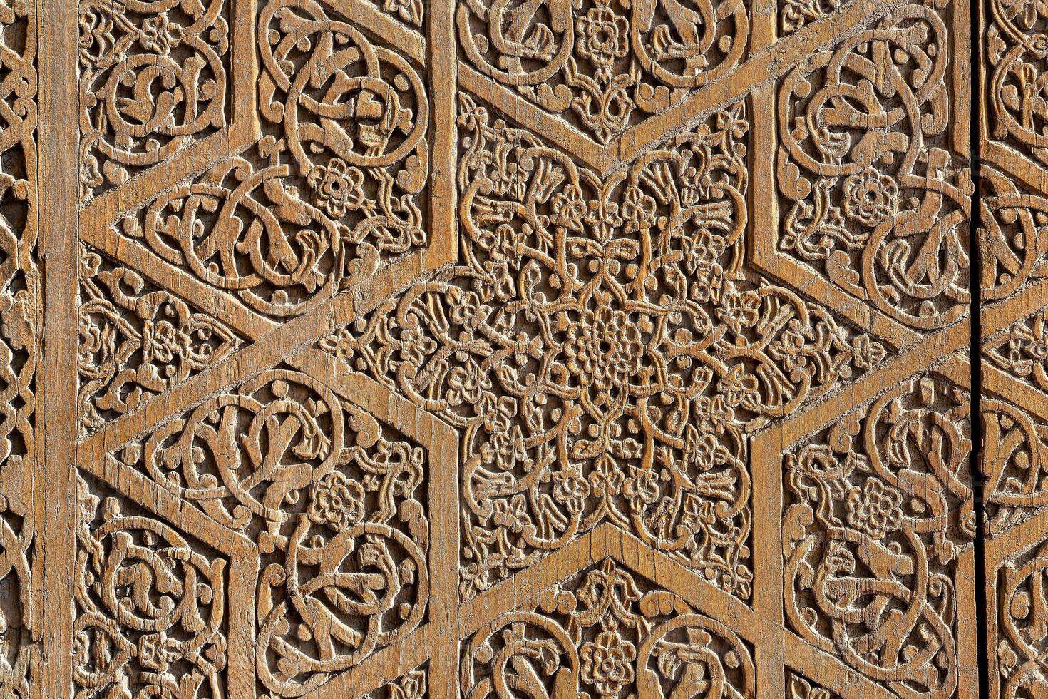 Fragment of an ancient carved wooden door. Ornate. photo