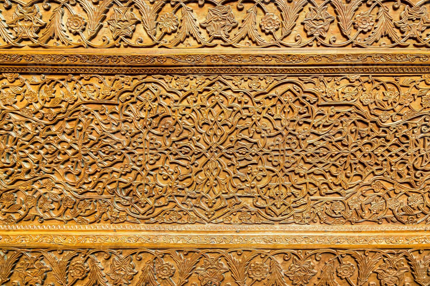 Fragment of an ancient carved wooden door. Ornate. photo