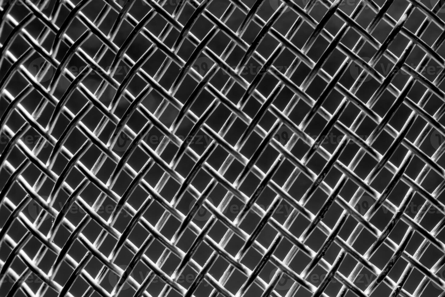 Monochrome texture of a shiny metal colander or grate. Abstract background. photo