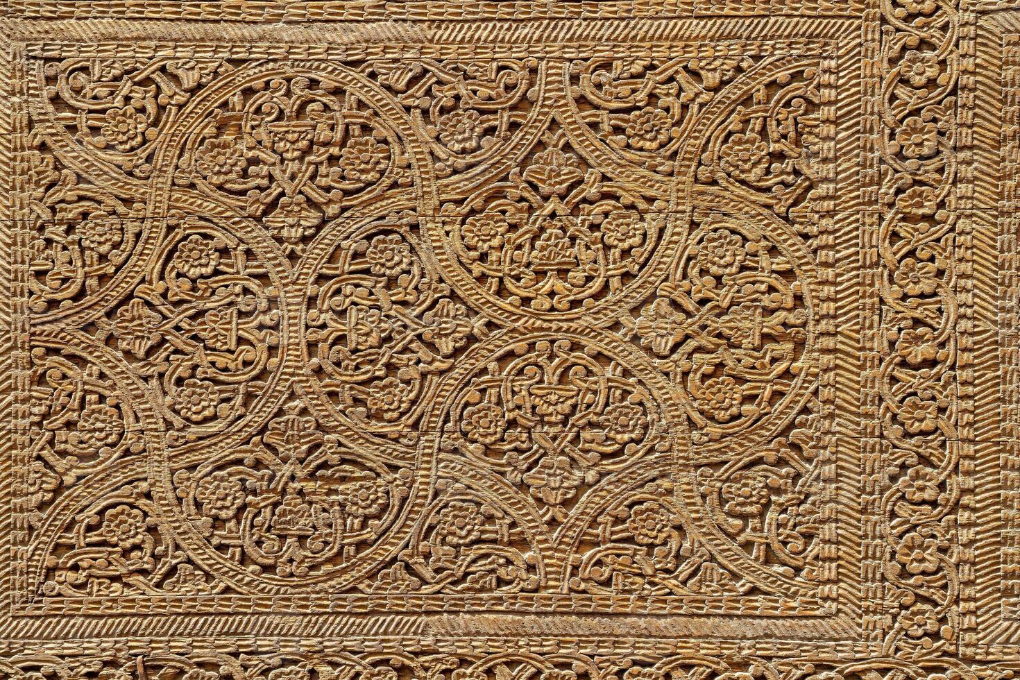 Fragment of an ancient carved wooden door. Ornate. photo