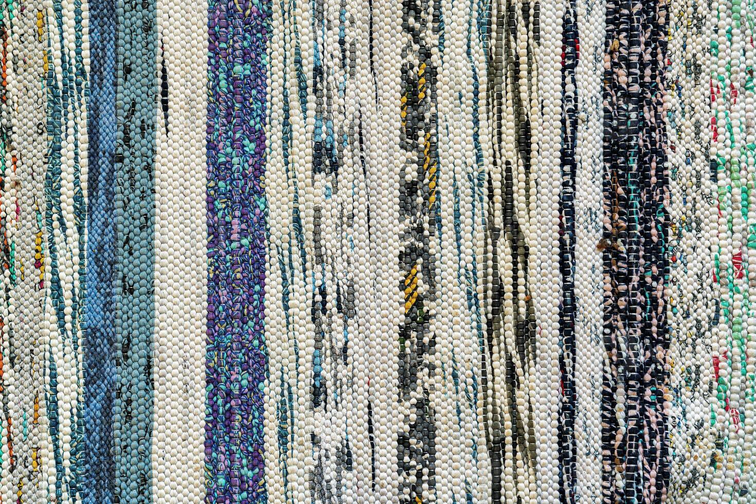 Texture of a multi-colored wicker floor carpet close-up. Abstract background. photo