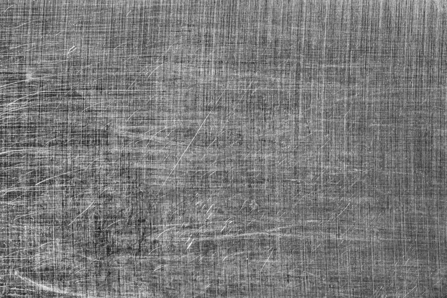 Monochrome texture of shiny scratched metal. Abstract background. photo