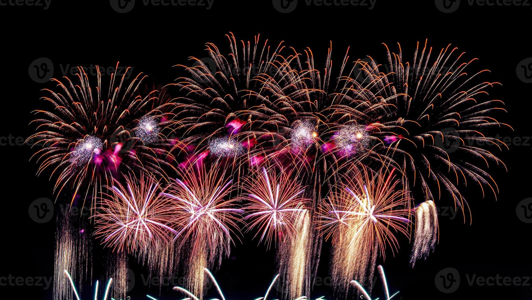 Colorful celebration fireworks isolated on a black sky background. photo