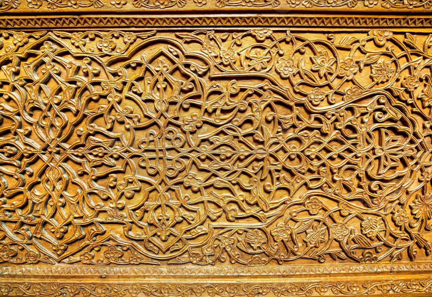 Fragment of an ancient carved wooden door. Ornate. photo