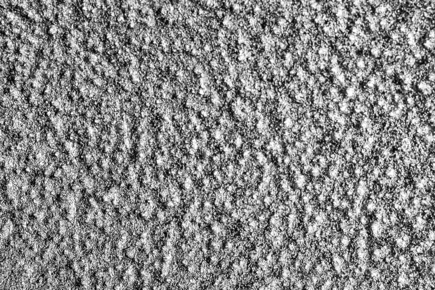 Monochrome texture of shiny grained metal. Abstract background. photo