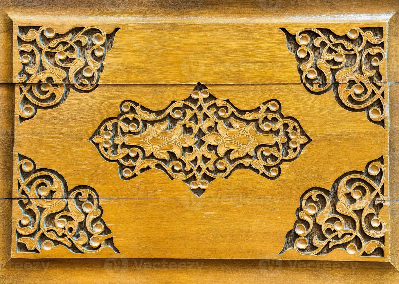 Fragment of an ancient carved wooden door. Ornate. photo