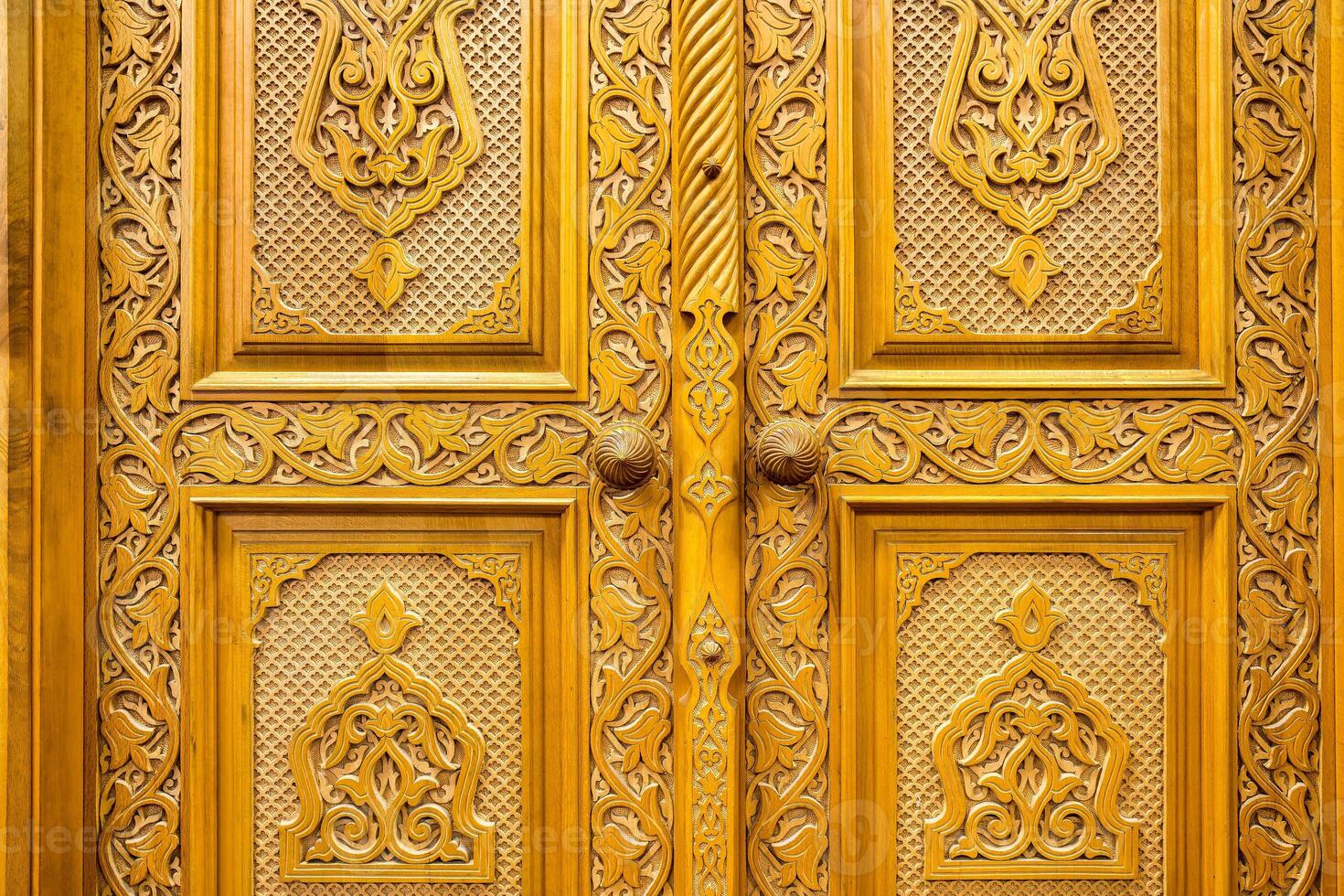 Carved wooden doors with patterns and mosaics. Abstract background. photo