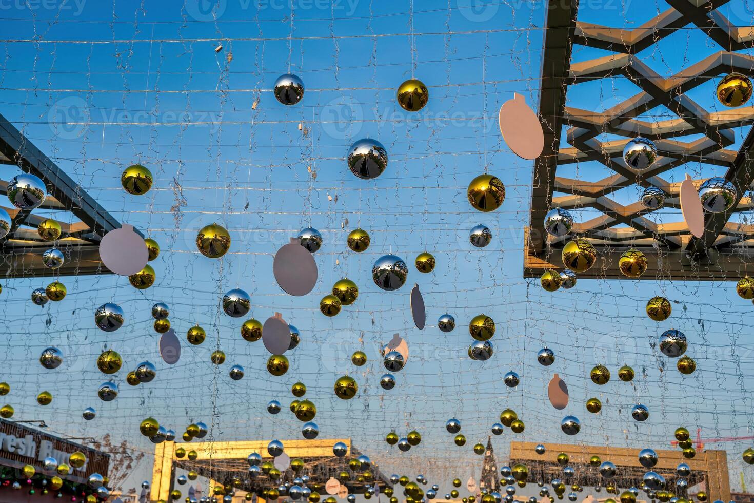 New Year or Christmas festive balls hanging in rows against the blue sky. photo