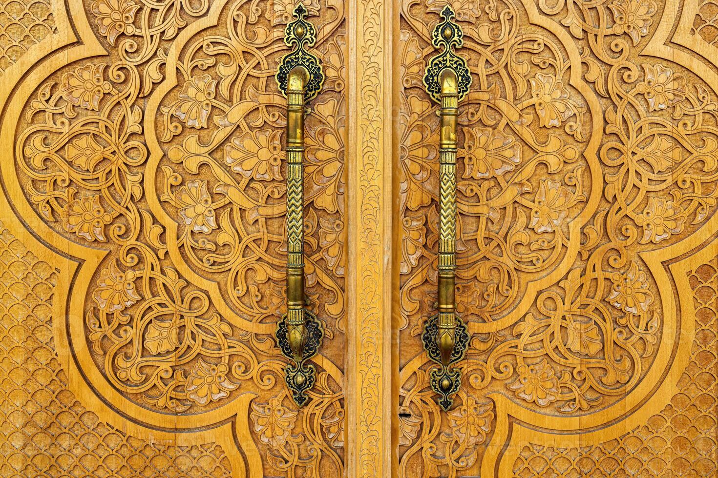 Carved wooden doors with patterns and mosaics. photo