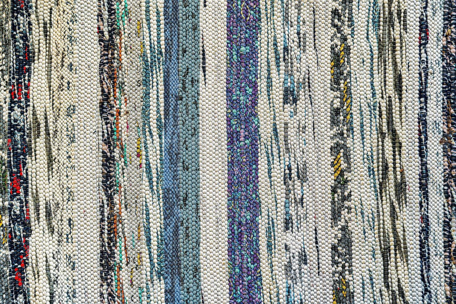 Texture of a multi-colored wicker floor carpet close-up. Abstract background. photo