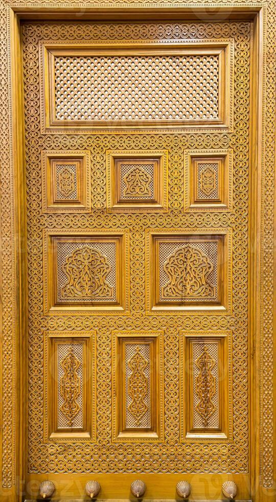 Carved wooden doors with patterns and mosaics. Abstract background. photo