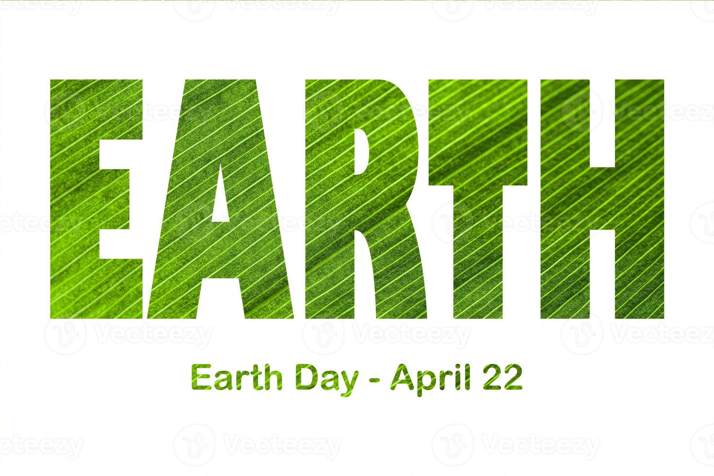 Lettering Earth Day April 22 on the background of lily of the valley leaf. Earth day concept, protection of the planet from pollution and improvement of environmental ecology. photo