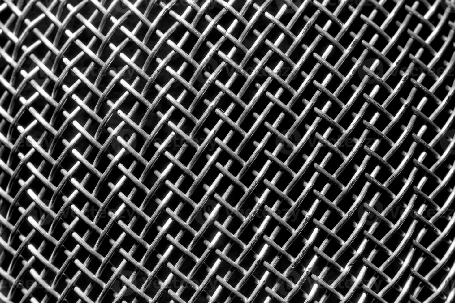 Monochrome texture of a shiny metal colander or grate. Abstract background. photo