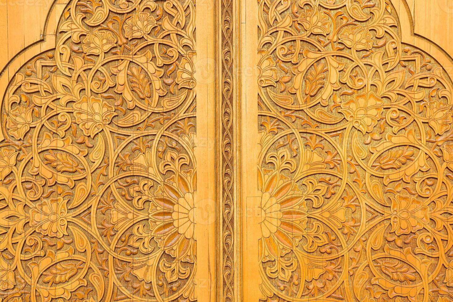 Carved wooden doors with patterns and mosaics. photo