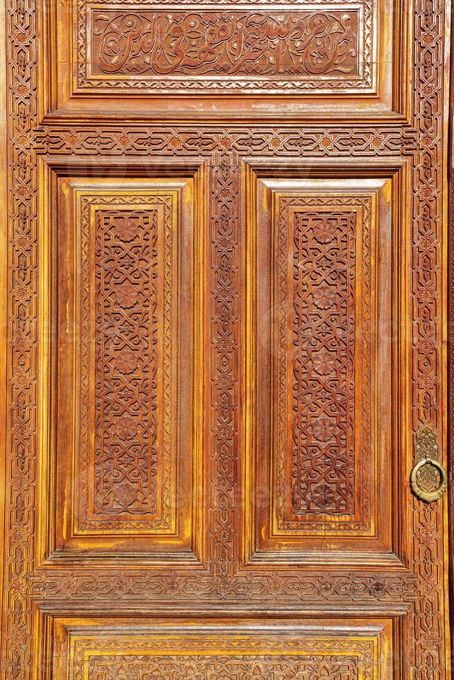 Carved wooden doors with patterns and mosaics. photo