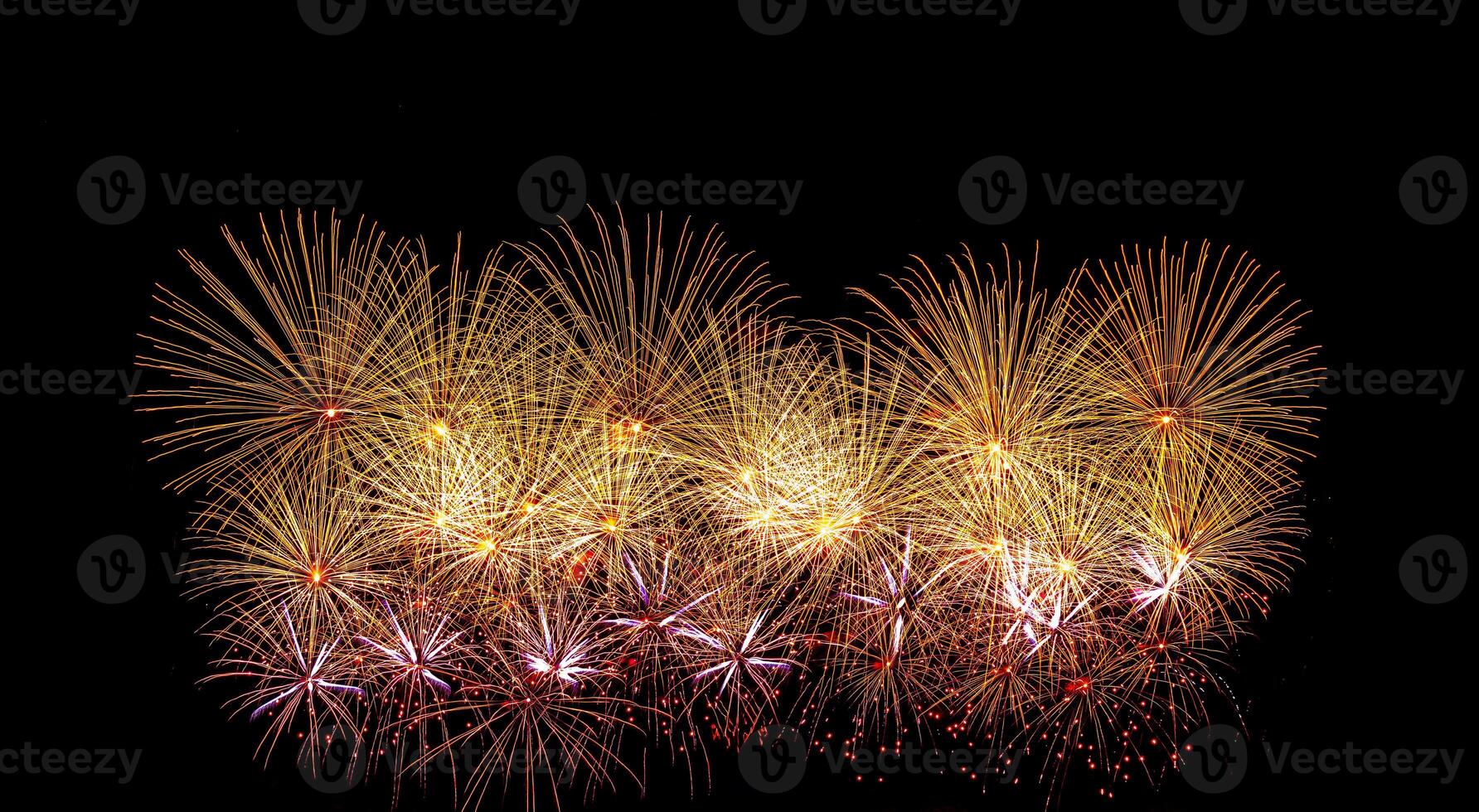 Colorful celebration fireworks isolated on a black sky background. photo