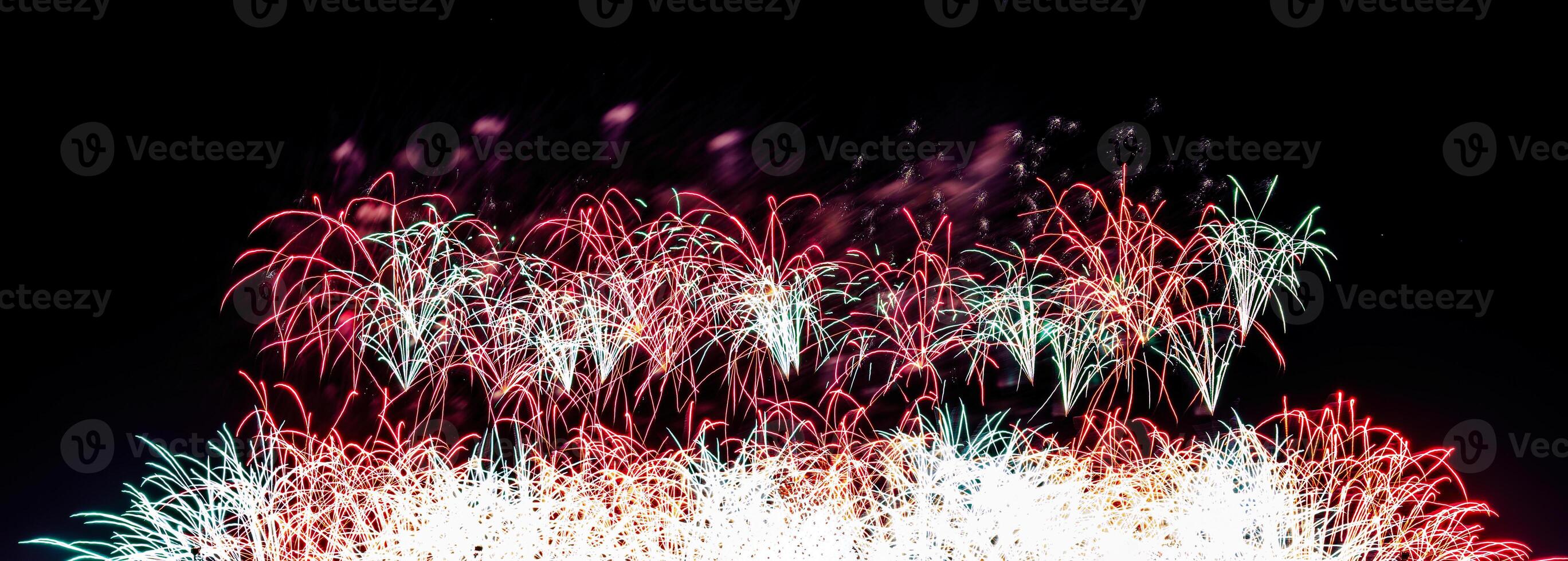 Colorful celebration fireworks isolated on a black sky background. photo