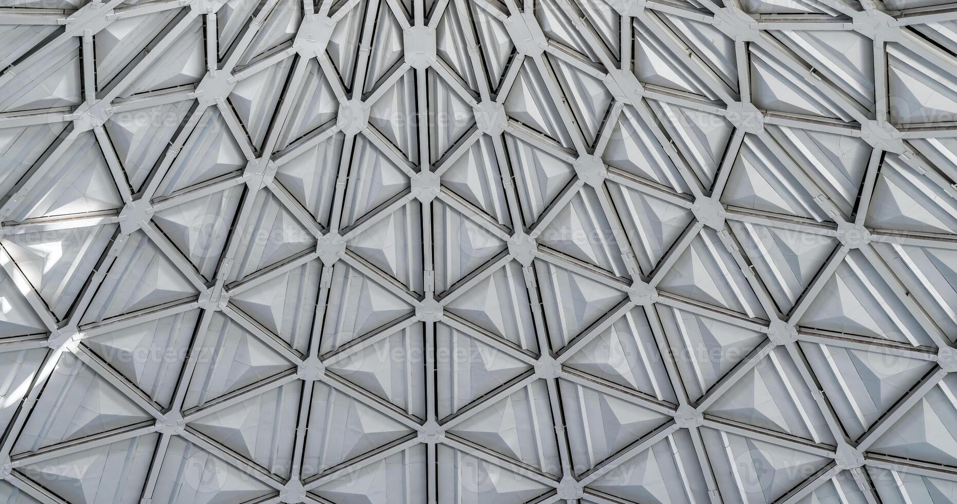 The steel inner part of the roof with the framework of the Chorsu Bazaar in Tashkent. Geometric architectural background. photo