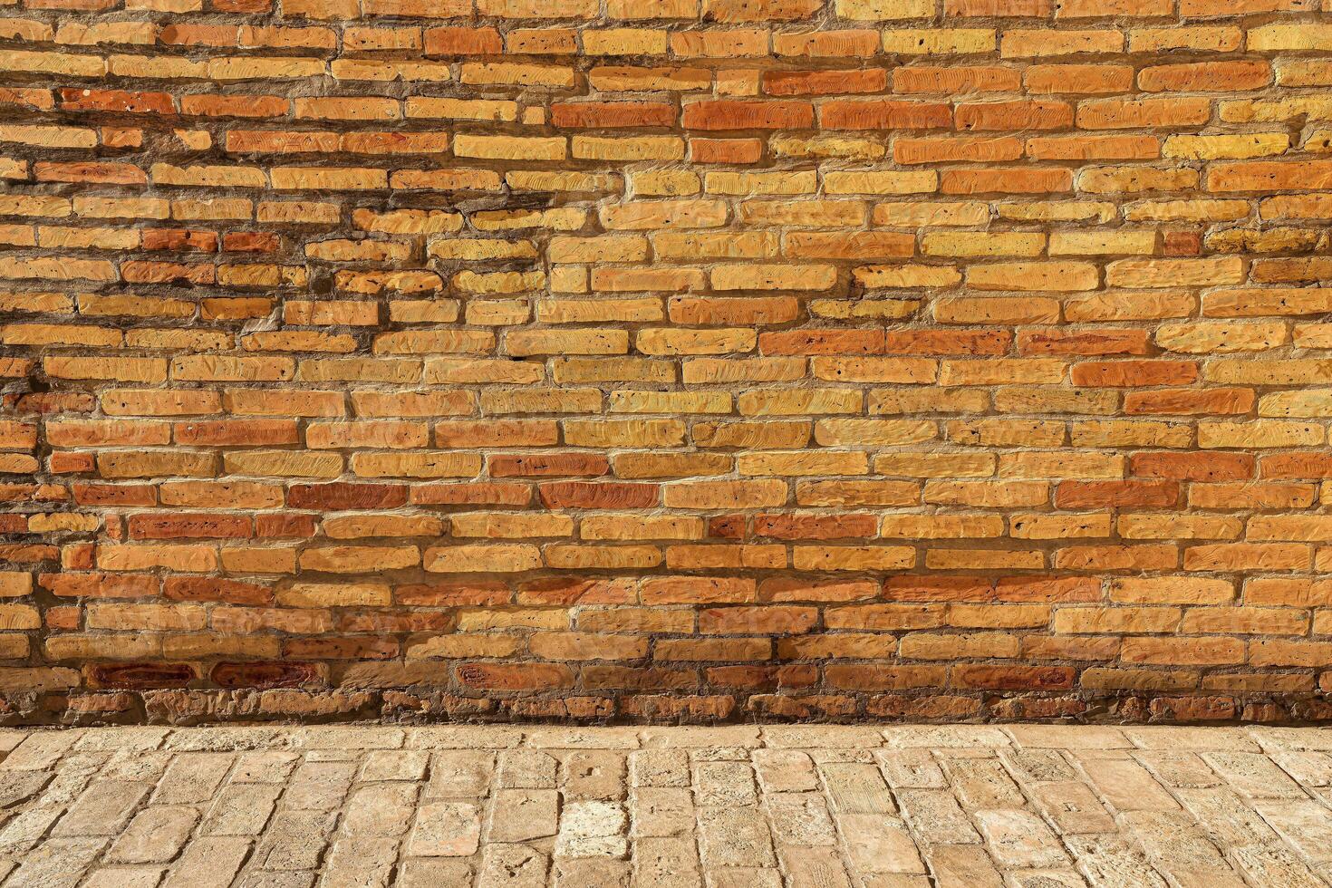 Old antique red brick wall and pavement texture. photo