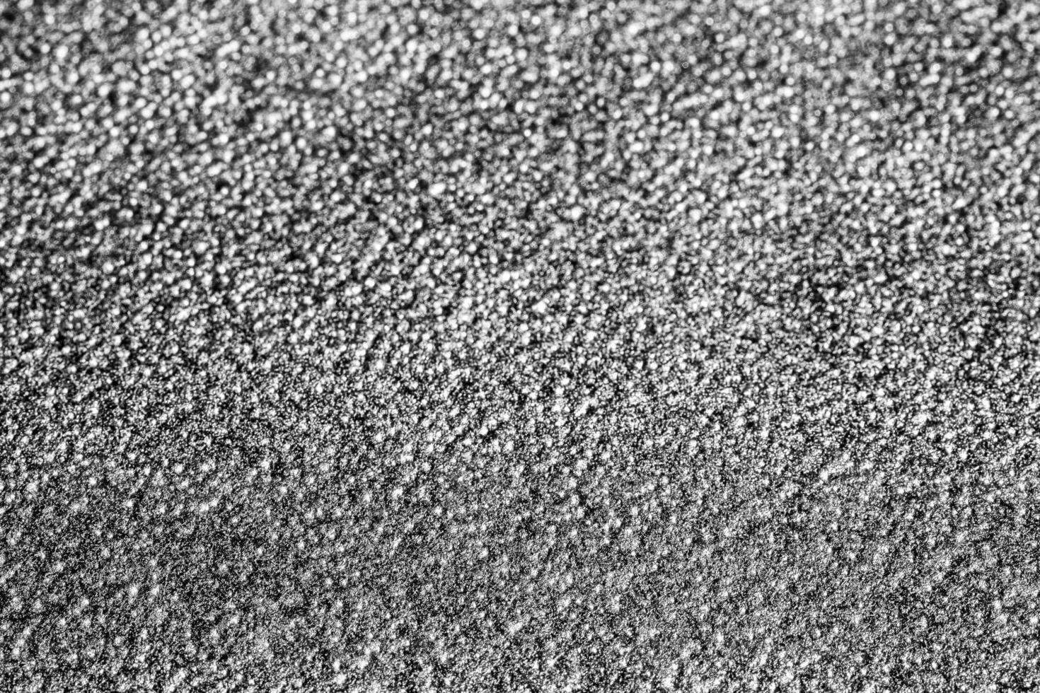 Monochrome texture of shiny grained metal. Abstract background. photo