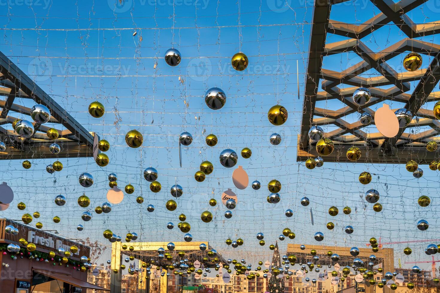 New Year or Christmas festive balls hanging in rows against the blue sky. photo