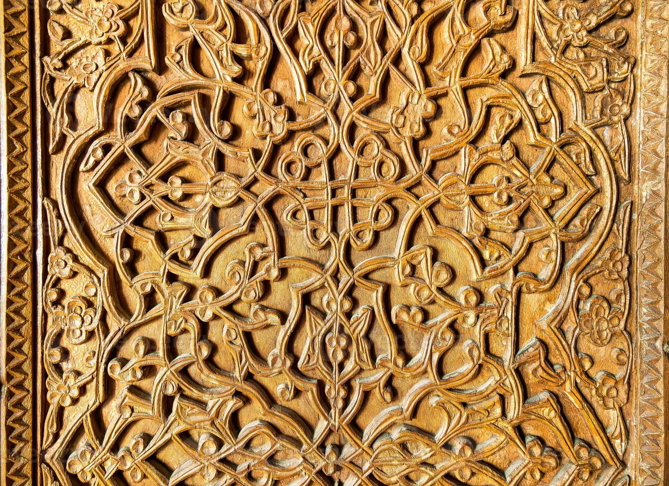 Fragment of an ancient carved wooden door. Ornate. photo