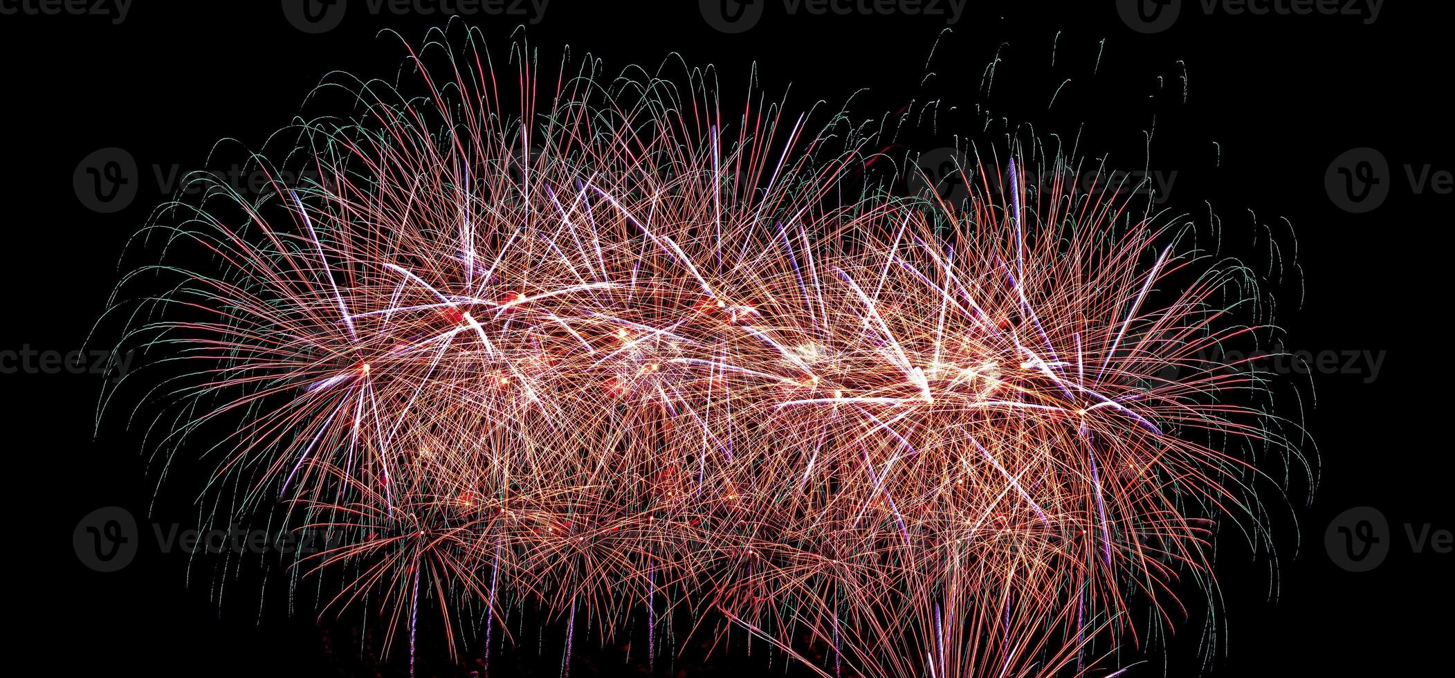 Colorful celebration fireworks isolated on a black sky background. photo