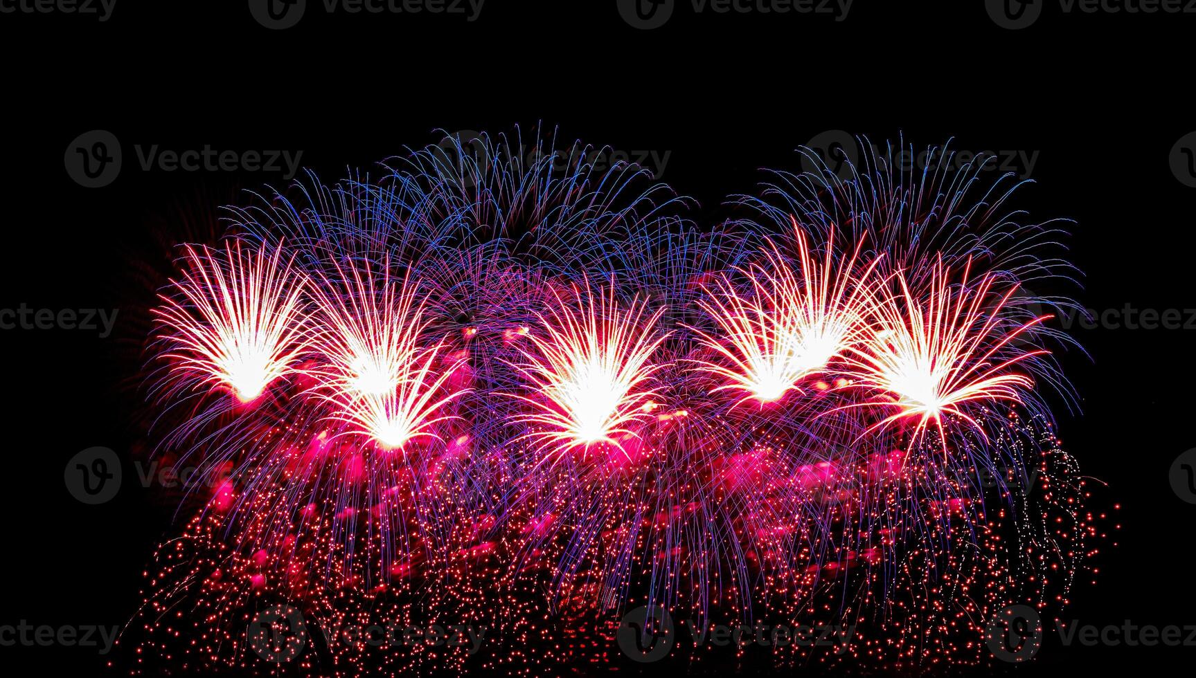 Colorful celebration fireworks isolated on a black sky background. photo
