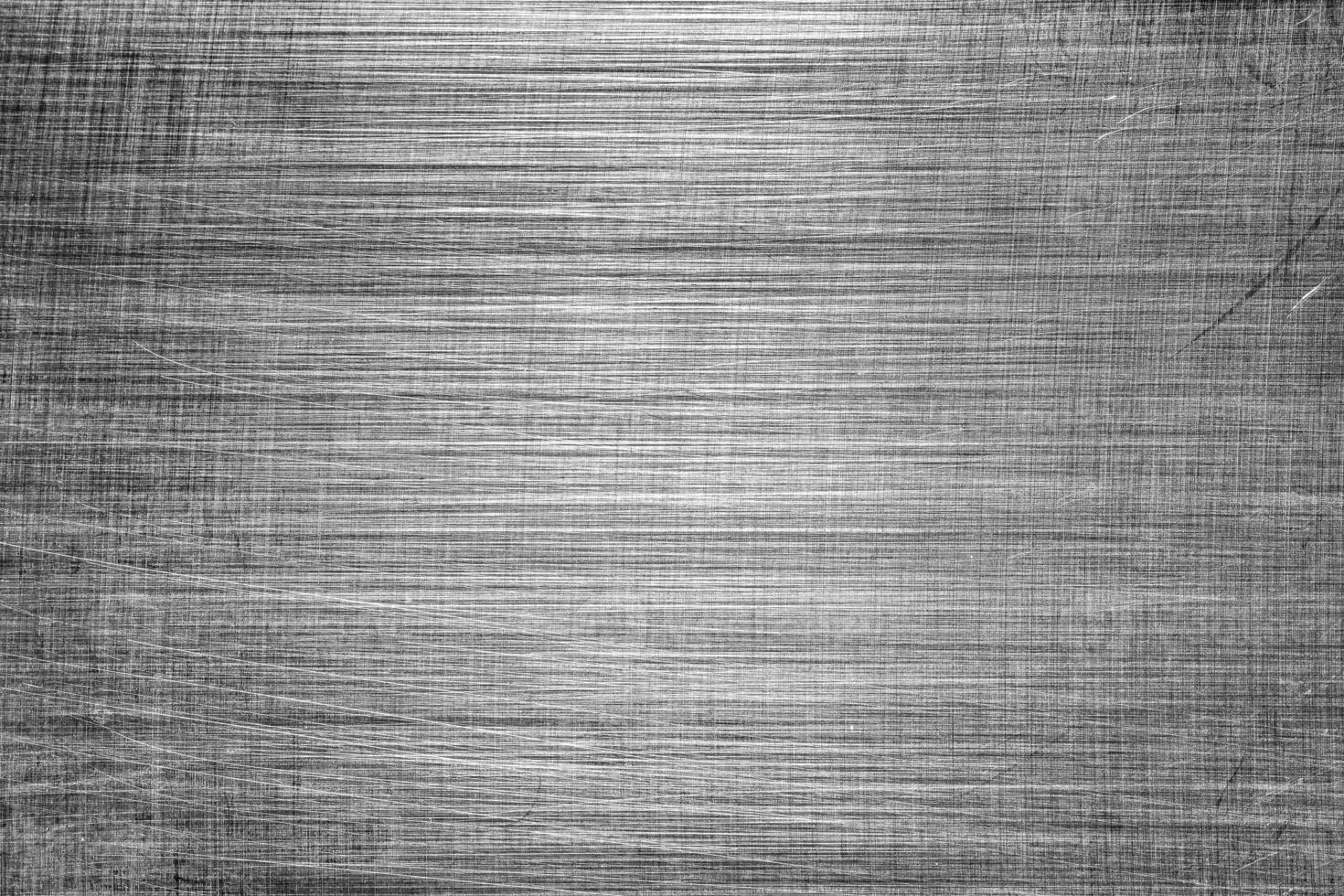 Monochrome texture of shiny scratched metal. Abstract background. photo