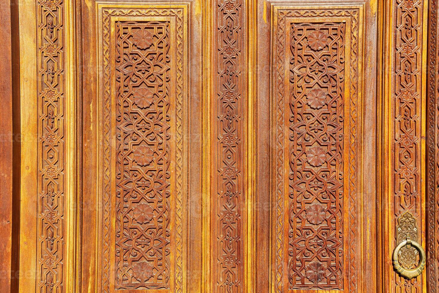 Carved wooden doors with patterns and mosaics. photo