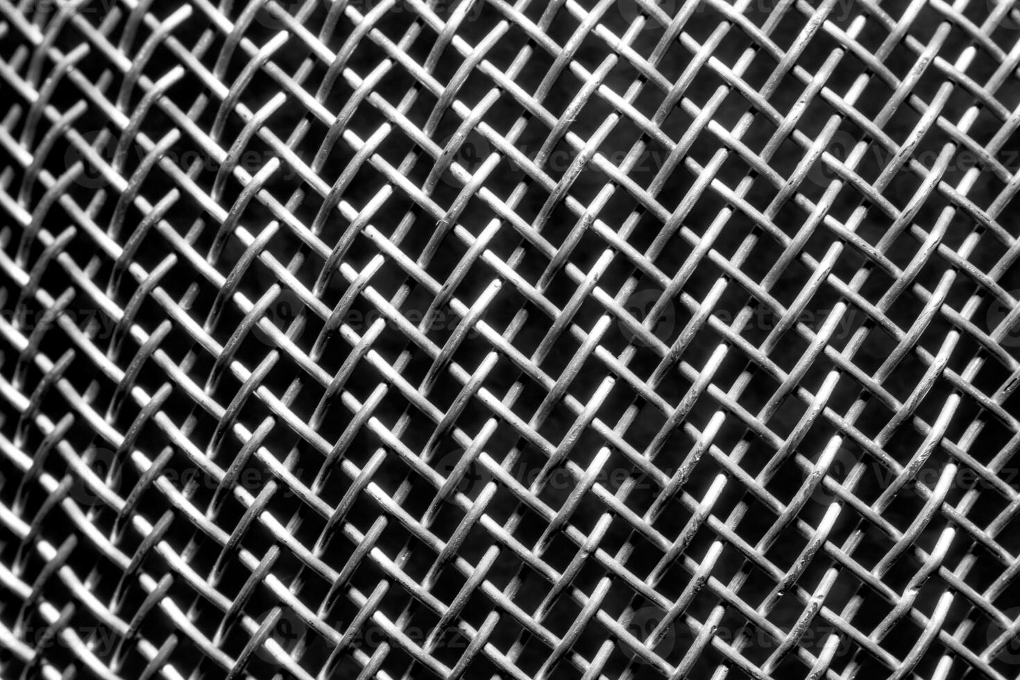 Monochrome texture of a shiny metal colander or grate. Abstract background. photo