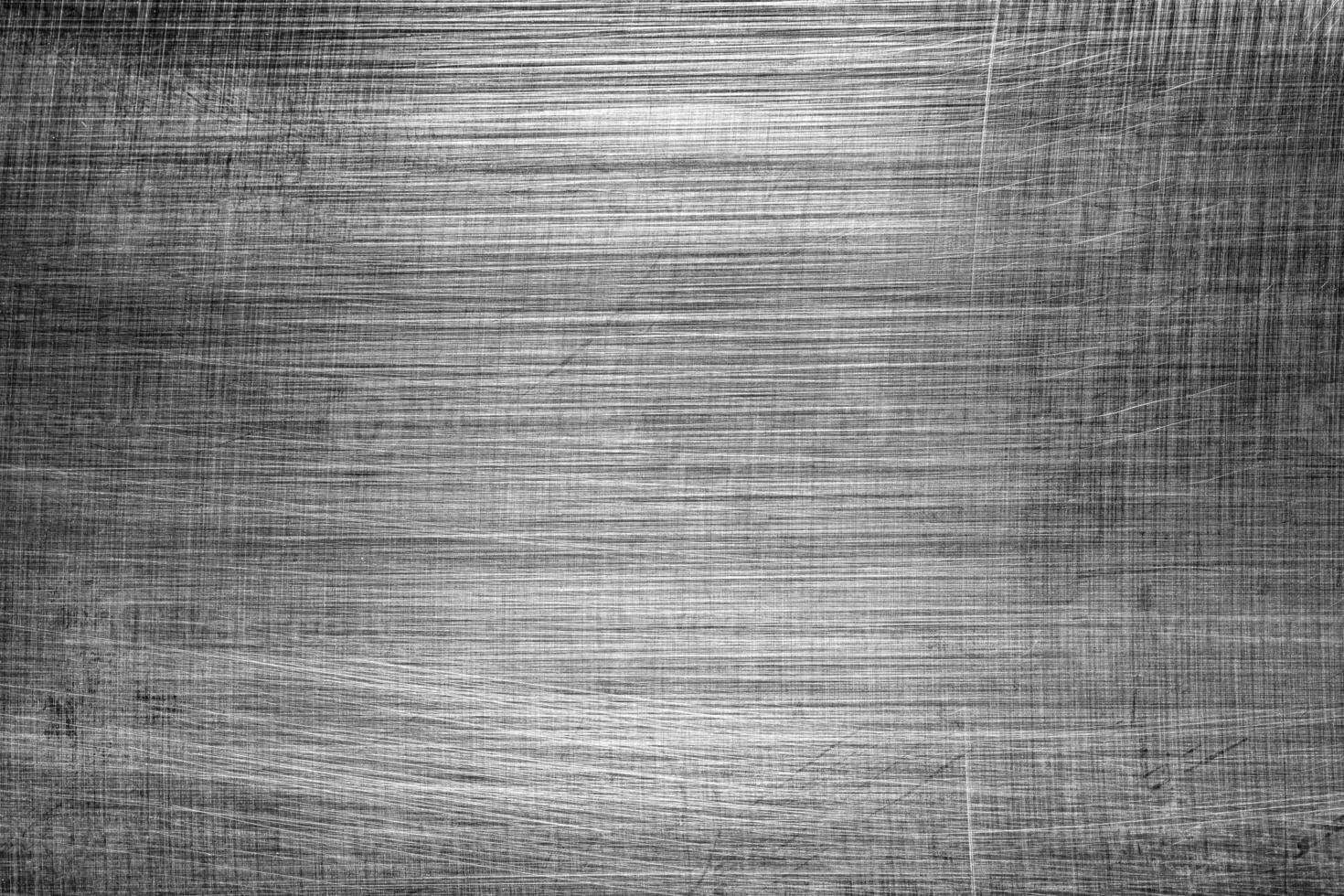 Monochrome texture of shiny scratched metal. Abstract background. photo