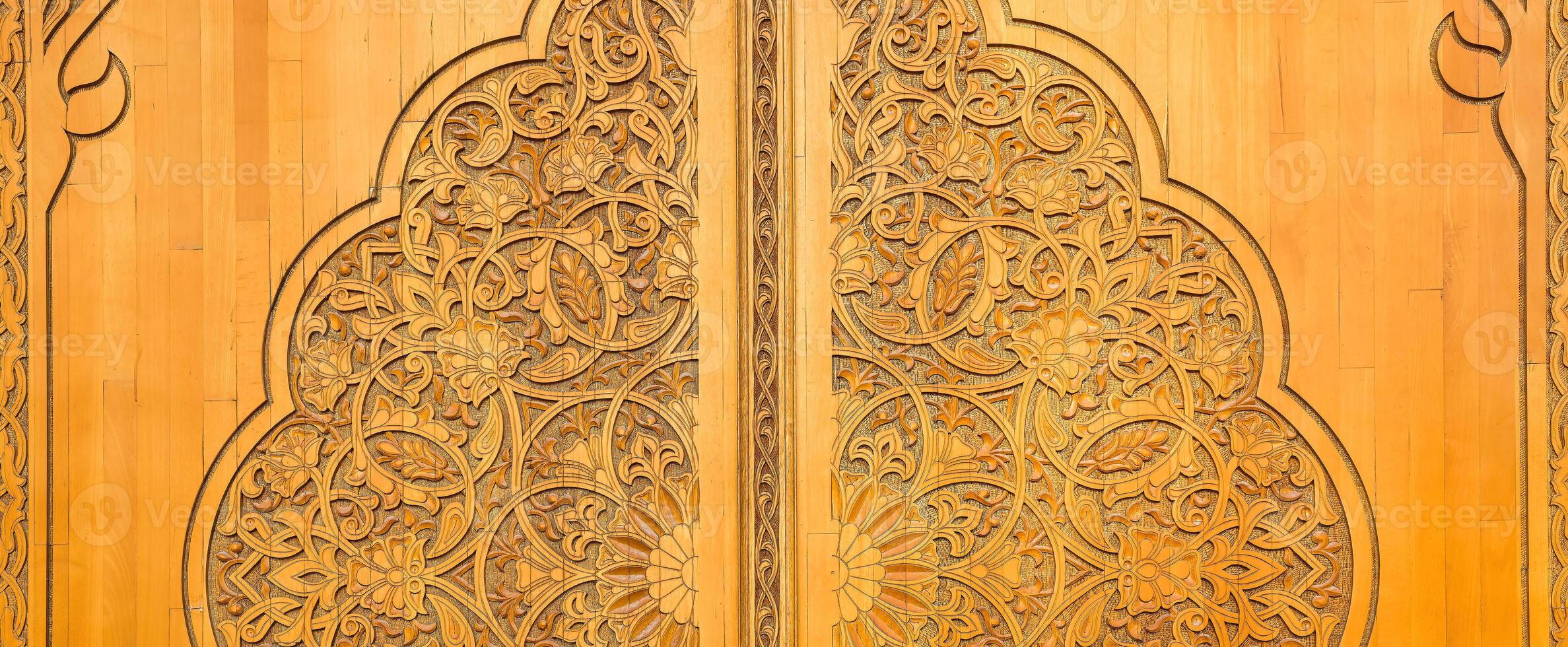 Carved wooden doors with patterns and mosaics. photo