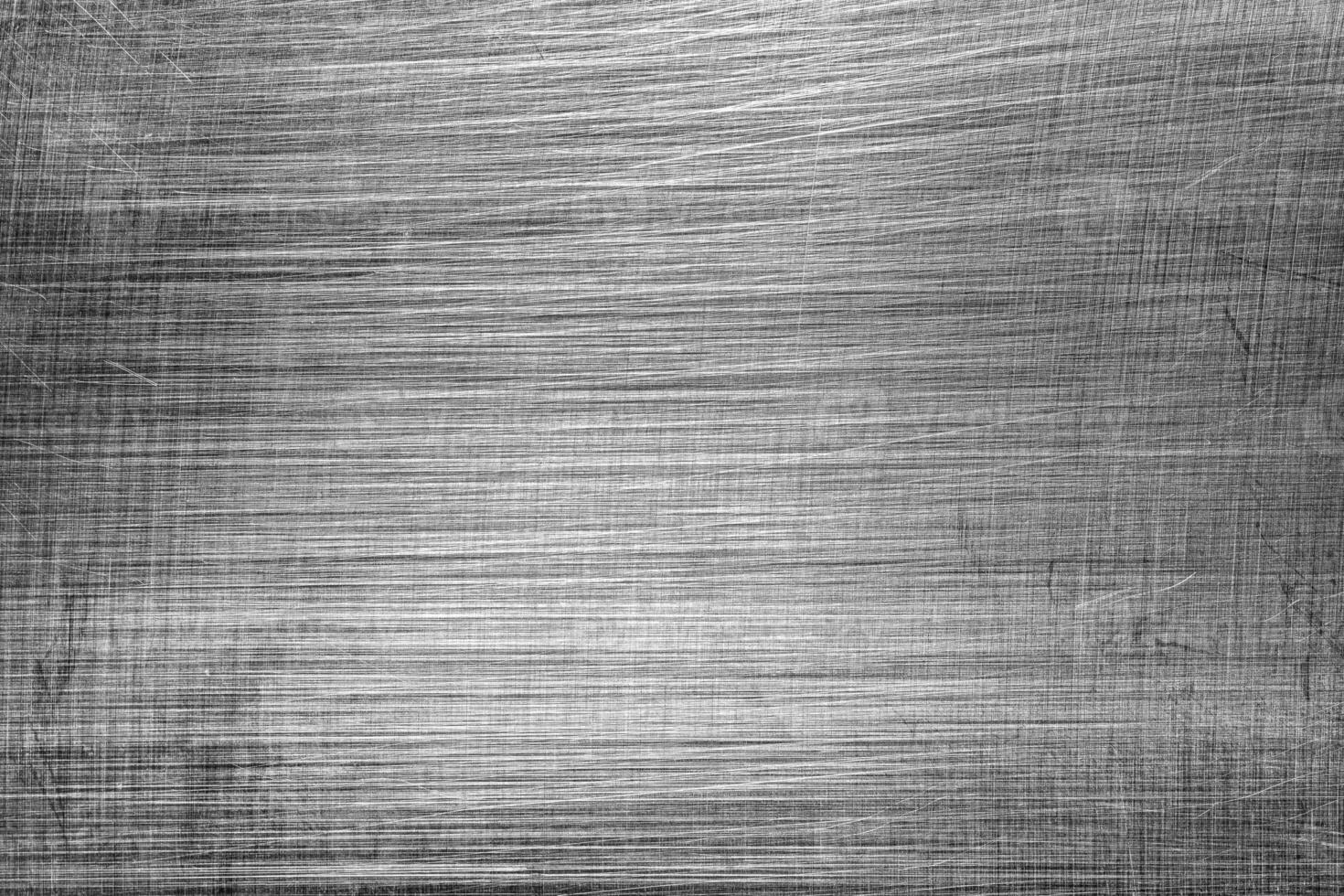 Monochrome texture of shiny scratched metal. Abstract background. photo