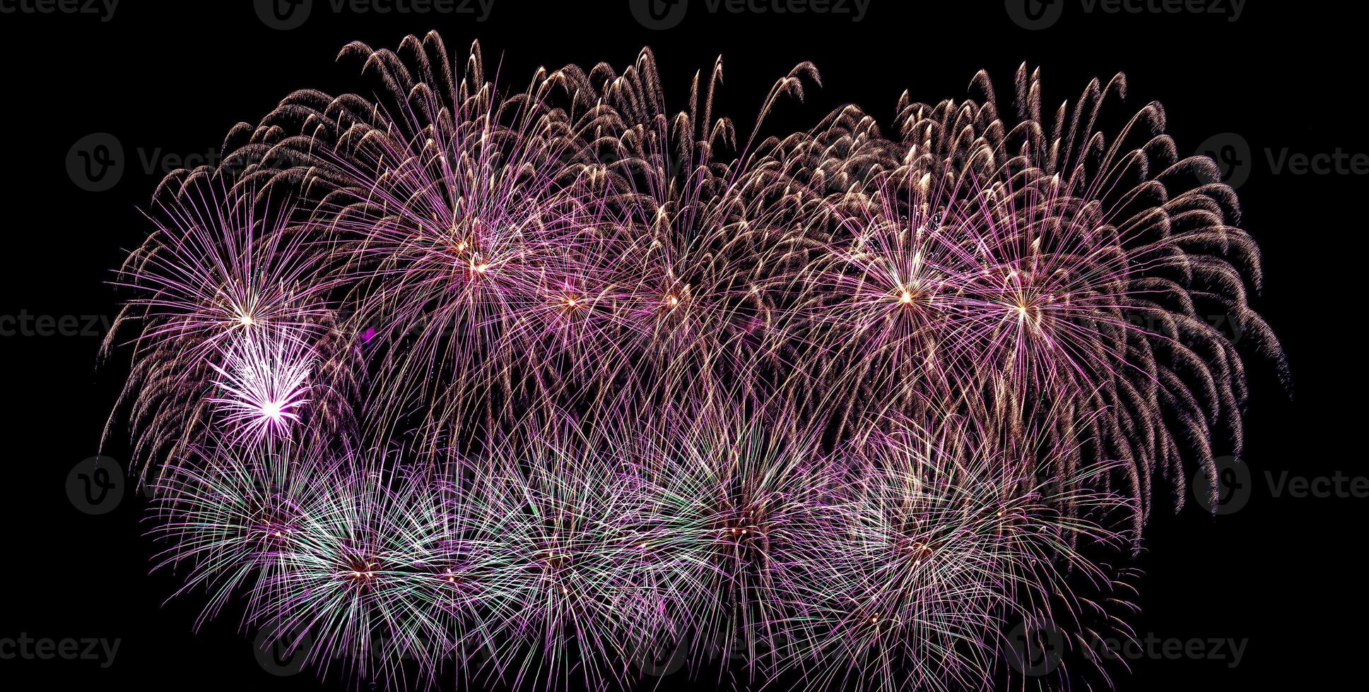 Colorful celebration fireworks isolated on a black sky background. photo