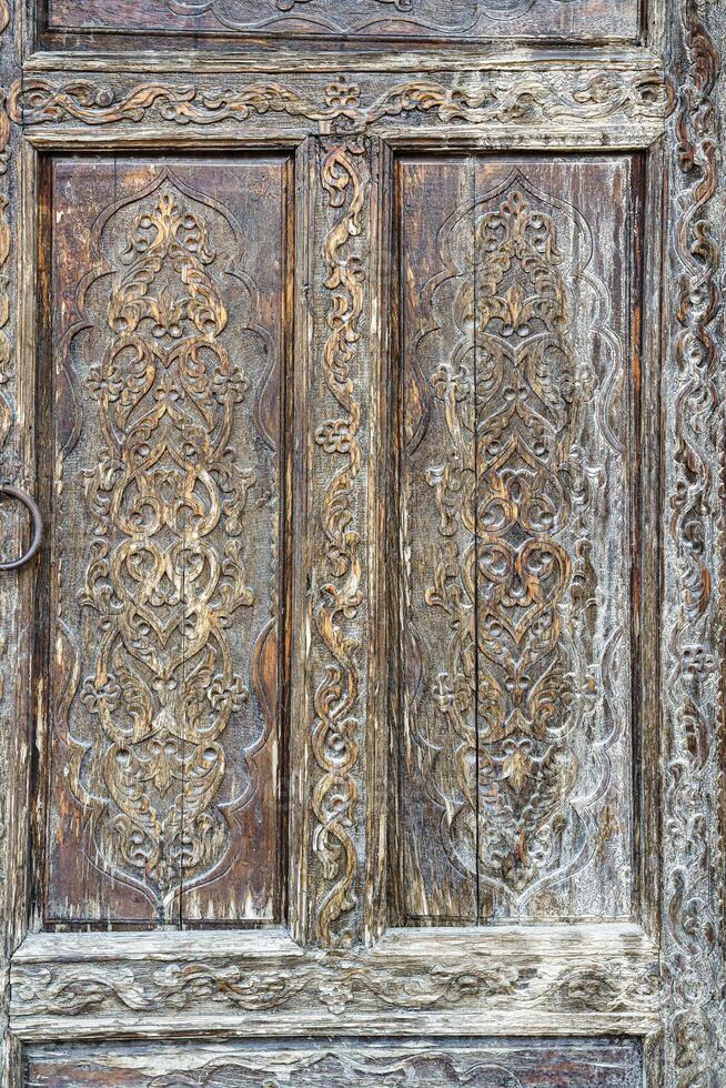 Carved wooden doors with patterns and mosaics. Abstract background for design. photo