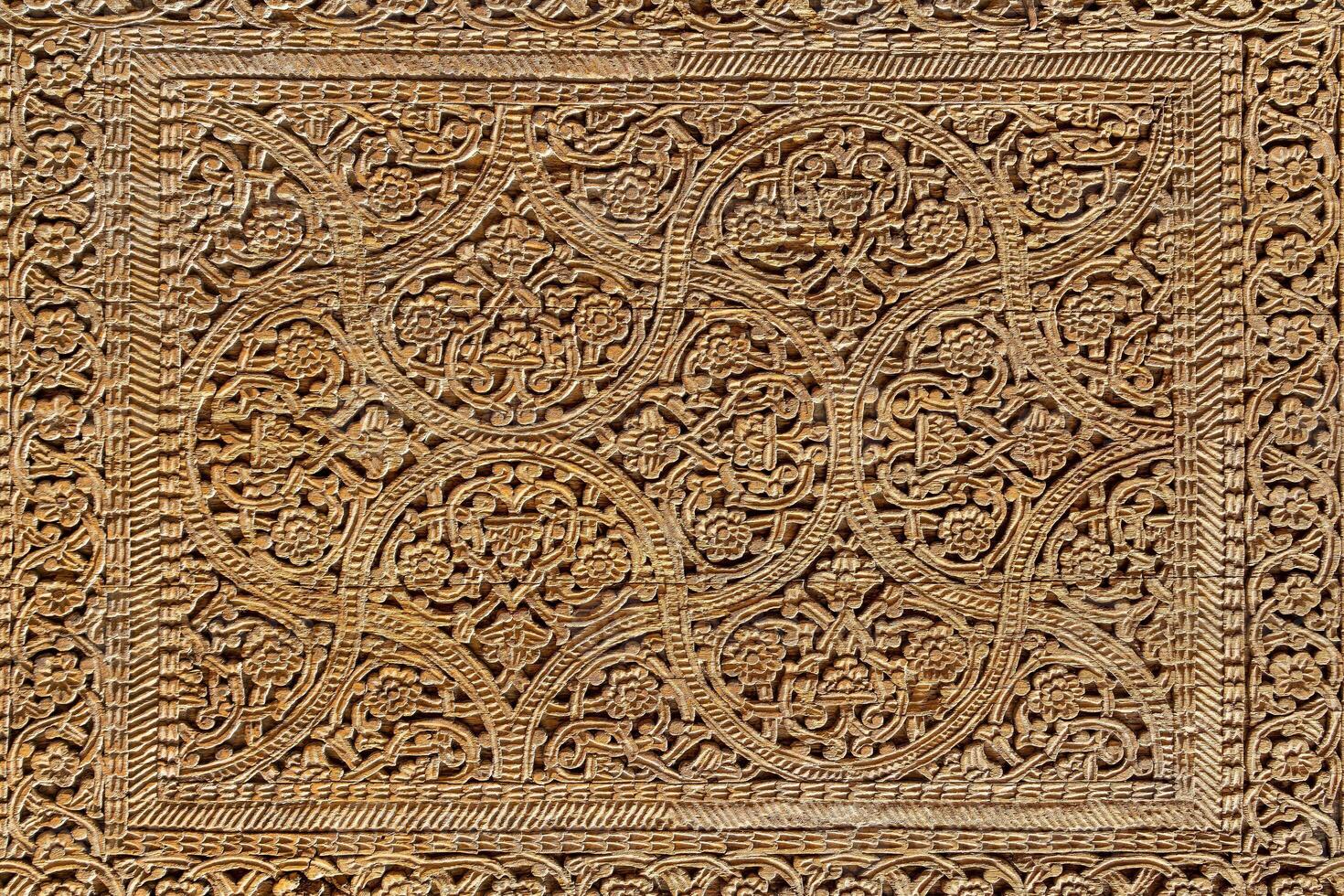 Fragment of an ancient carved wooden door. Ornate. photo