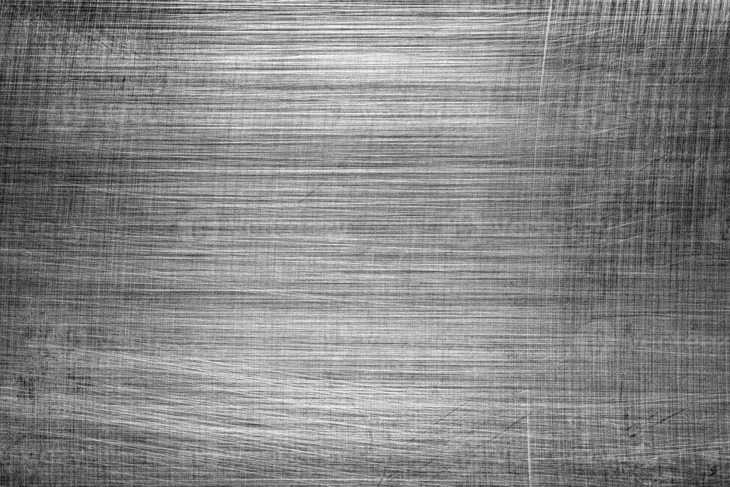 Monochrome texture of shiny scratched metal. Abstract background. photo