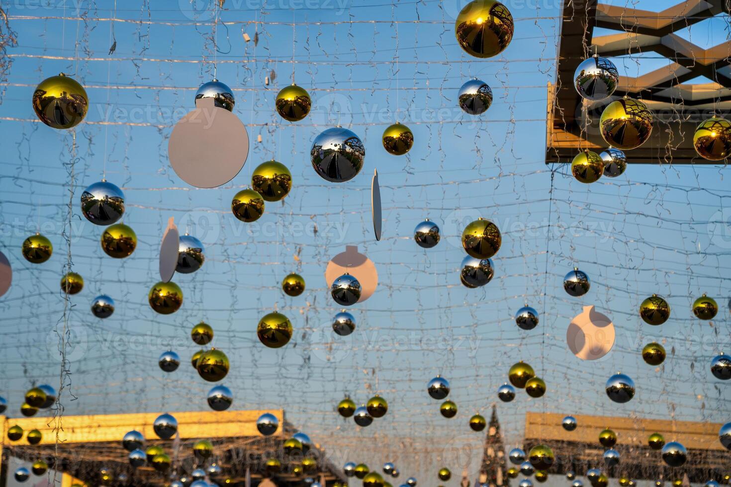 New Year or Christmas festive balls hanging in rows against the blue sky. photo