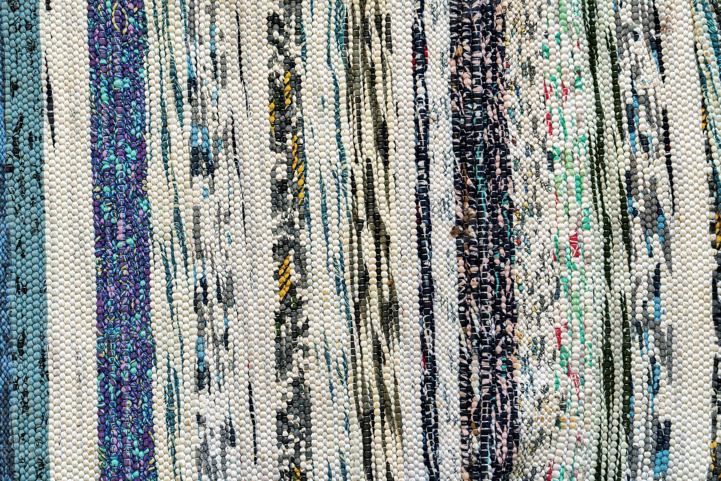 Texture of a multi-colored wicker floor carpet close-up. Abstract background. photo